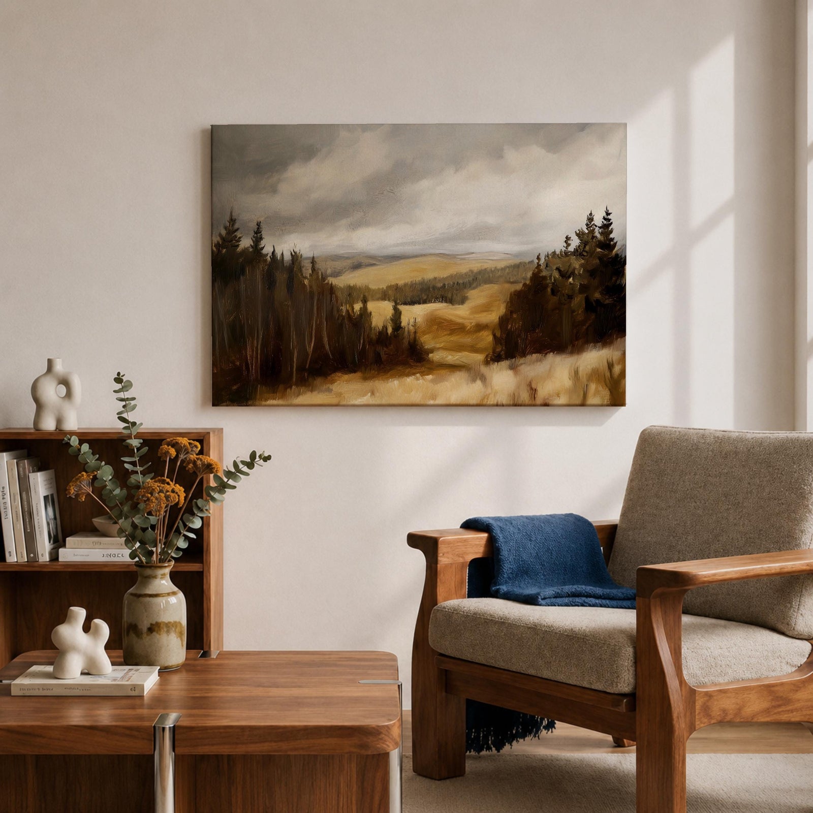 A framed canvas painting depicting a wildflower meadow landscape with rolling hills and clusters of trees under a cloudy sky. The artwork captures a natural countryside scene with detailed brushwork and a warm, rustic atmosphere emphasizing the beauty of open fields and forest edges.