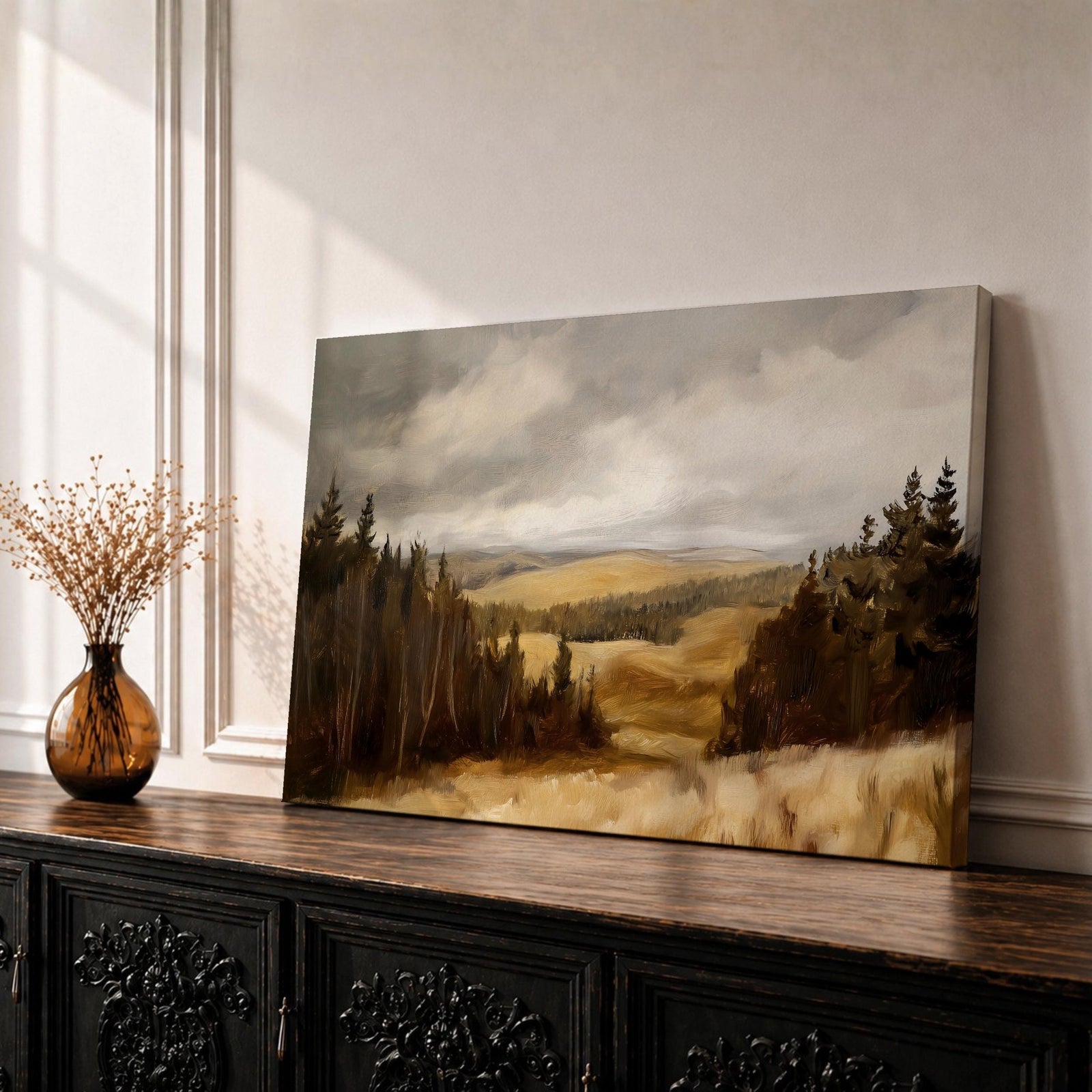 A framed canvas painting depicting a wildflower meadow landscape with rolling hills and clusters of trees under a cloudy sky. The artwork captures a natural countryside scene with detailed brushwork and a warm, rustic atmosphere emphasizing the beauty of open fields and forest edges.