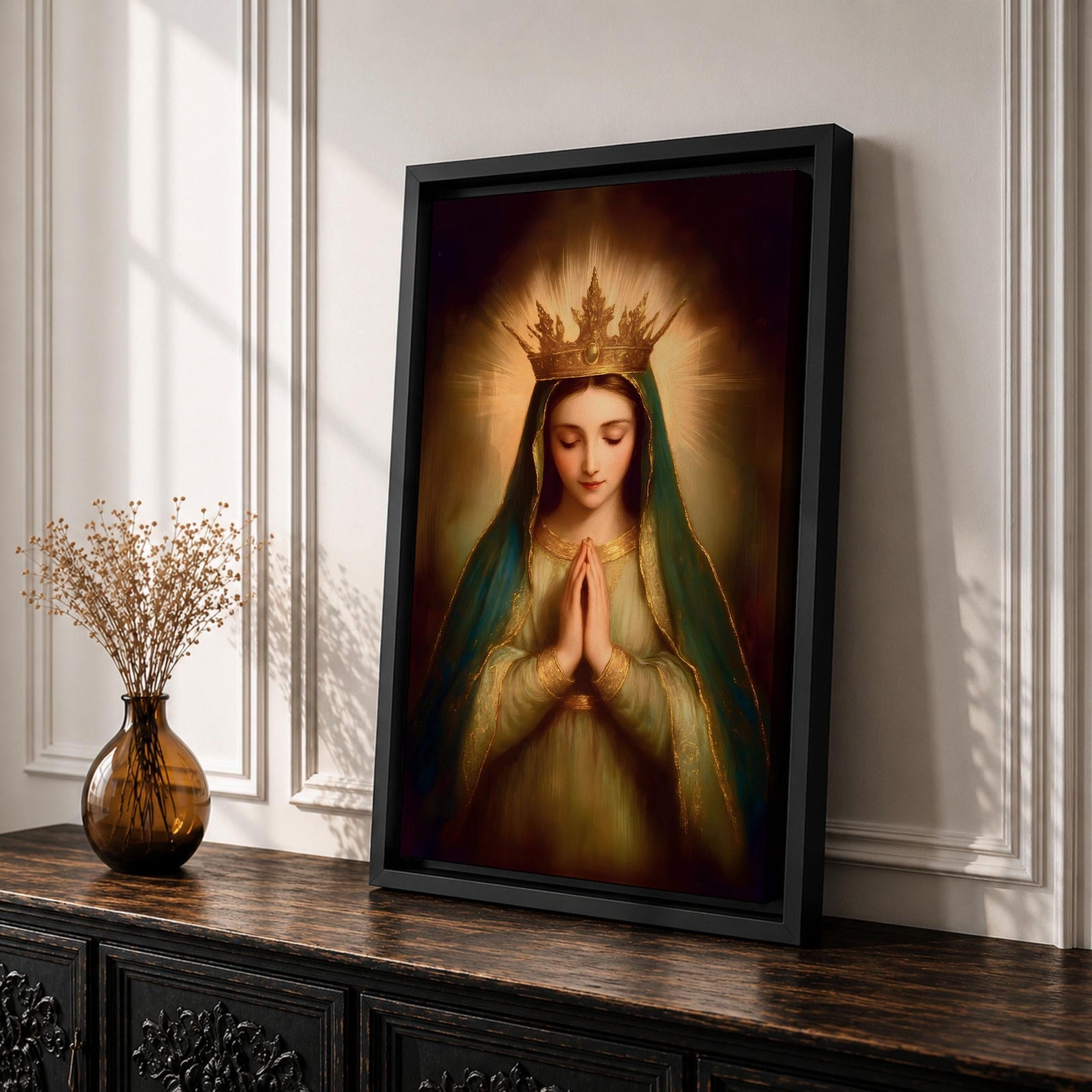 Painting of the Virgin Mary crowned as Queen of Heaven with a radiant golden crown and halo, shown with eyes closed and hands gently folded in prayer. She wears a long veil and flowing robe while soft classical brushwork and a glowing background emphasize the Marian figure in a devotional royal portrait.