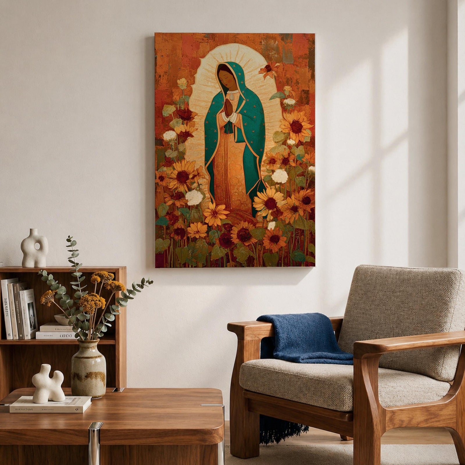 This artwork depicts Our Lady of Guadalupe, also known as the Virgin of Guadalupe, surrounded by vibrant sunflowers and floral elements in a vintage style. The figure is shown with hands clasped in prayer, wearing a teal mantle adorned with stars, set against a warm textured background.
