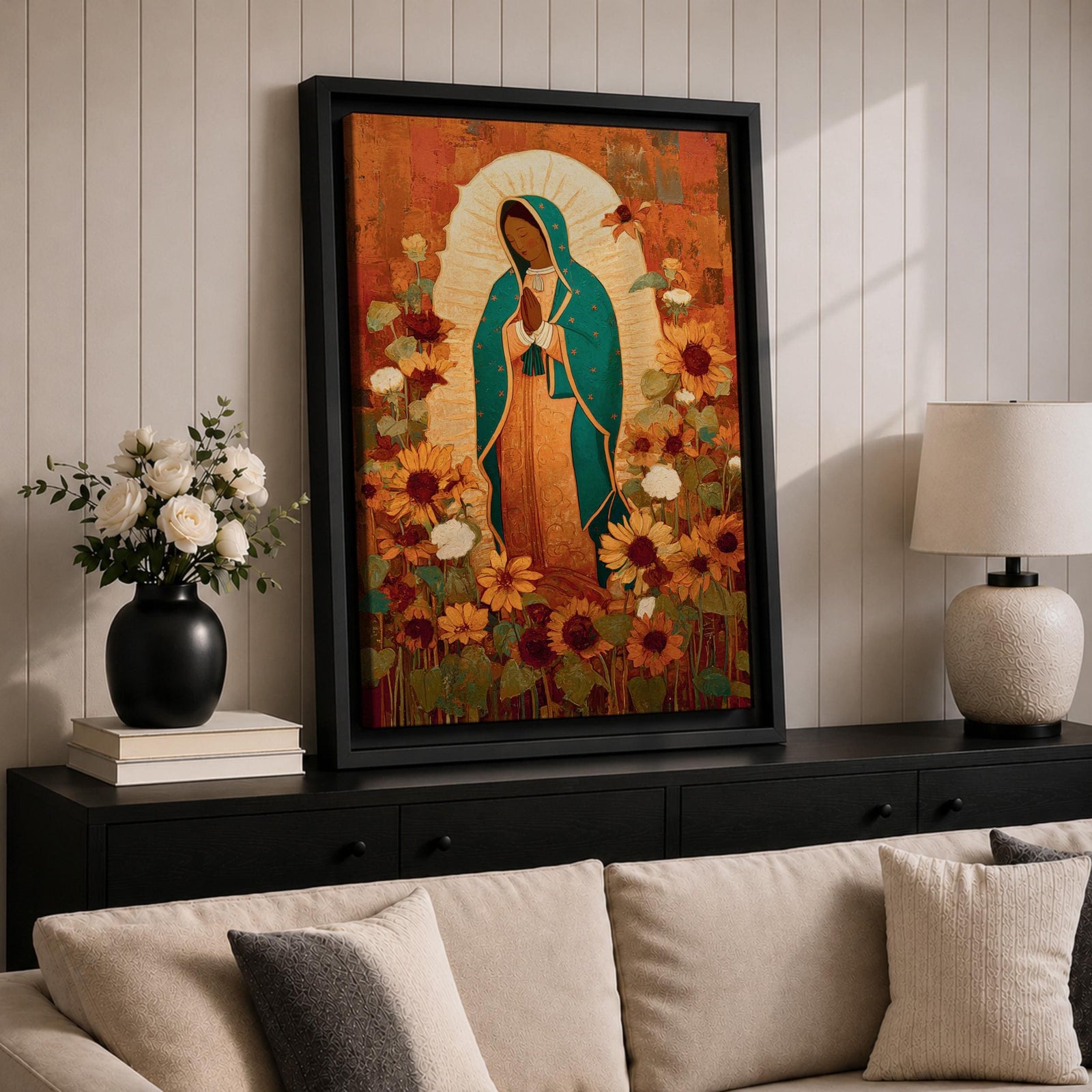 This artwork depicts Our Lady of Guadalupe, also known as the Virgin of Guadalupe, surrounded by vibrant sunflowers and floral elements in a vintage style. The figure is shown with hands clasped in prayer, wearing a teal mantle adorned with stars, set against a warm textured background.