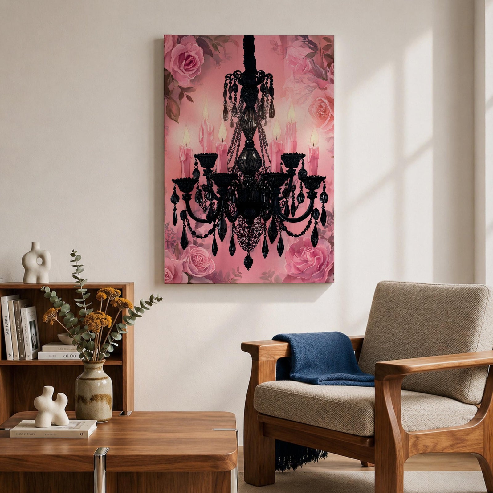 A framed canvas print featuring a detailed black chandelier silhouette with multiple hanging crystals and candle flames, set against a pink floral background with roses, blending ornate lighting design with a soft botanical motif.
