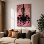 A framed canvas print featuring a detailed black chandelier silhouette with multiple hanging crystals and candle flames, set against a pink floral background with roses, blending ornate lighting design with a soft botanical motif.