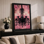 A framed canvas print featuring a detailed black chandelier silhouette with multiple hanging crystals and candle flames, set against a pink floral background with roses, blending ornate lighting design with a soft botanical motif.