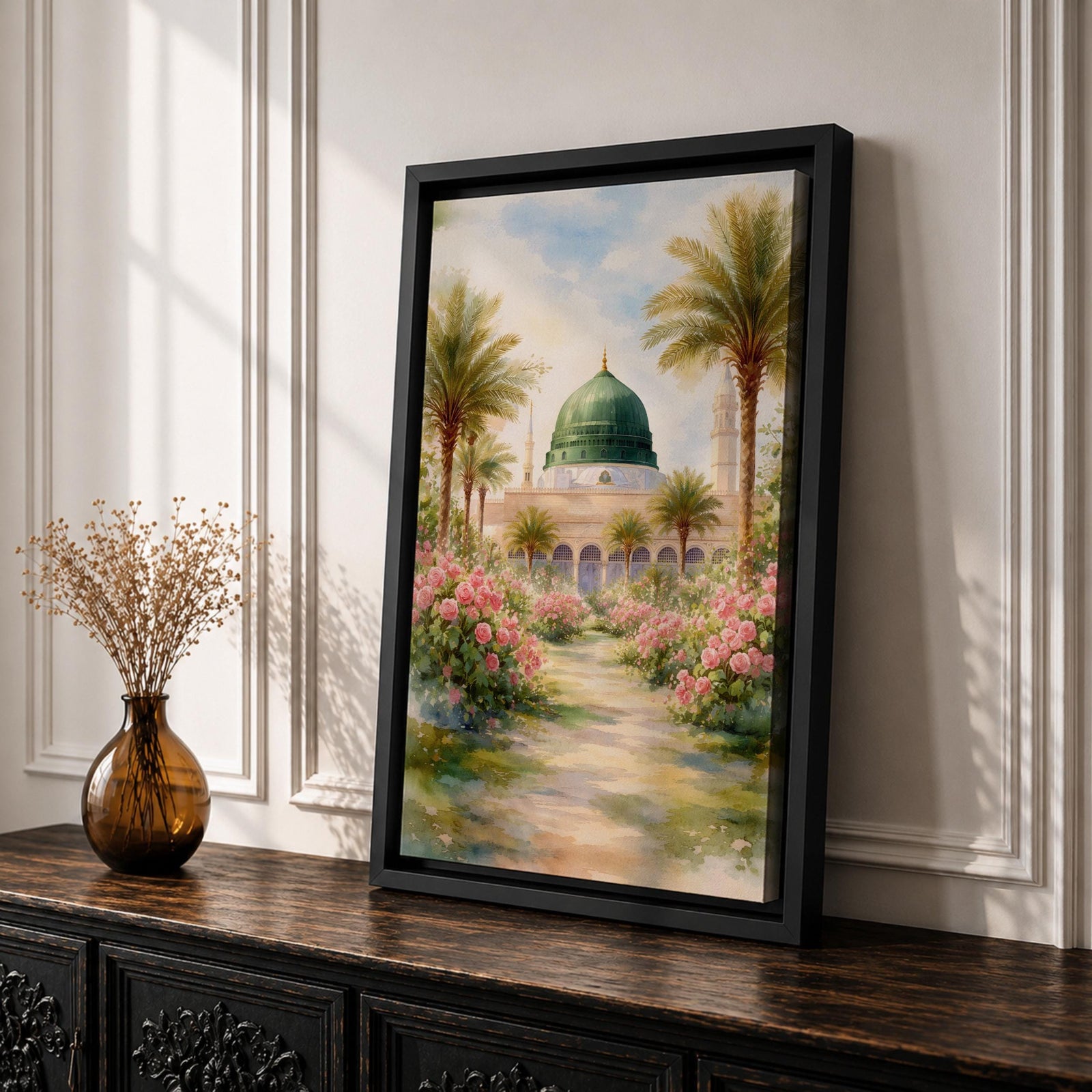 Framed canvas wall art of the Prophet’s Mosque in Medina featuring the iconic green dome, surrounded by palm trees and blooming pink flowers along a sunlit garden path, creating a peaceful and serene Islamic landscape scene for home decor.