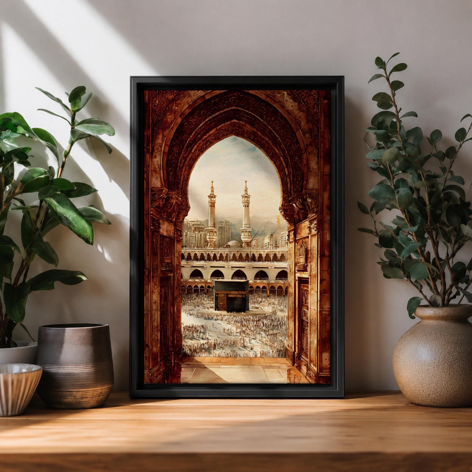 Artwork showing the Kaaba in Mecca viewed through an ornate Islamic archway with intricate carved stone details, overlooking the Masjid al Haram courtyard filled with pilgrims and surrounded by minarets and mosque architecture under warm sunlight.