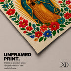 A framed stitched style art print depicting Our Lady of Guadalupe with hands clasped in prayer, surrounded by a radiant golden halo and vibrant floral embroidery in red, blue, and green. The image captures the traditional Mexican Catholic iconography with intricate textile detail and a serene expression.