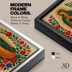 A framed stitched style art print depicting Our Lady of Guadalupe with hands clasped in prayer, surrounded by a radiant golden halo and vibrant floral embroidery in red, blue, and green. The image captures the traditional Mexican Catholic iconography with intricate textile detail and a serene expression.