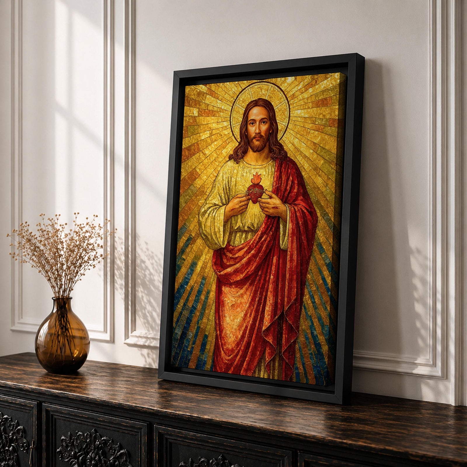 A mosaic-style depiction of the Sacred Heart of Jesus shows Jesus with a radiant golden halo and rays emanating behind him. He wears a red robe over a white garment and holds a flaming heart at his chest. The artwork features intricate mosaic tile textures and vibrant colors.