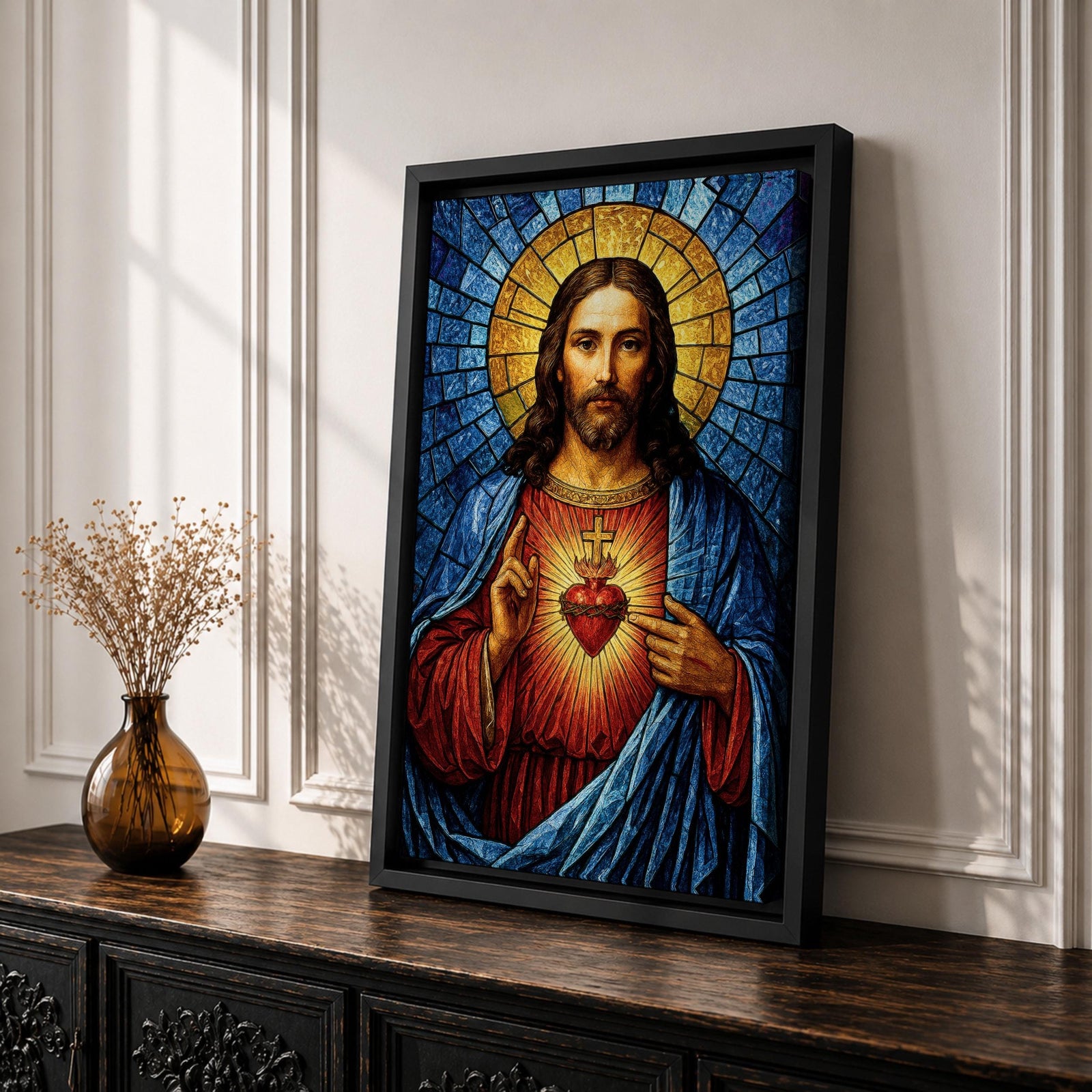 A stained glass style depiction of the Sacred Heart of Jesus shows Jesus with long hair and beard, wearing a red robe and blue cloak. His heart is radiant with light, crowned with a cross and surrounded by thorns. The background features geometric blue and gold stained glass tiles forming a halo.