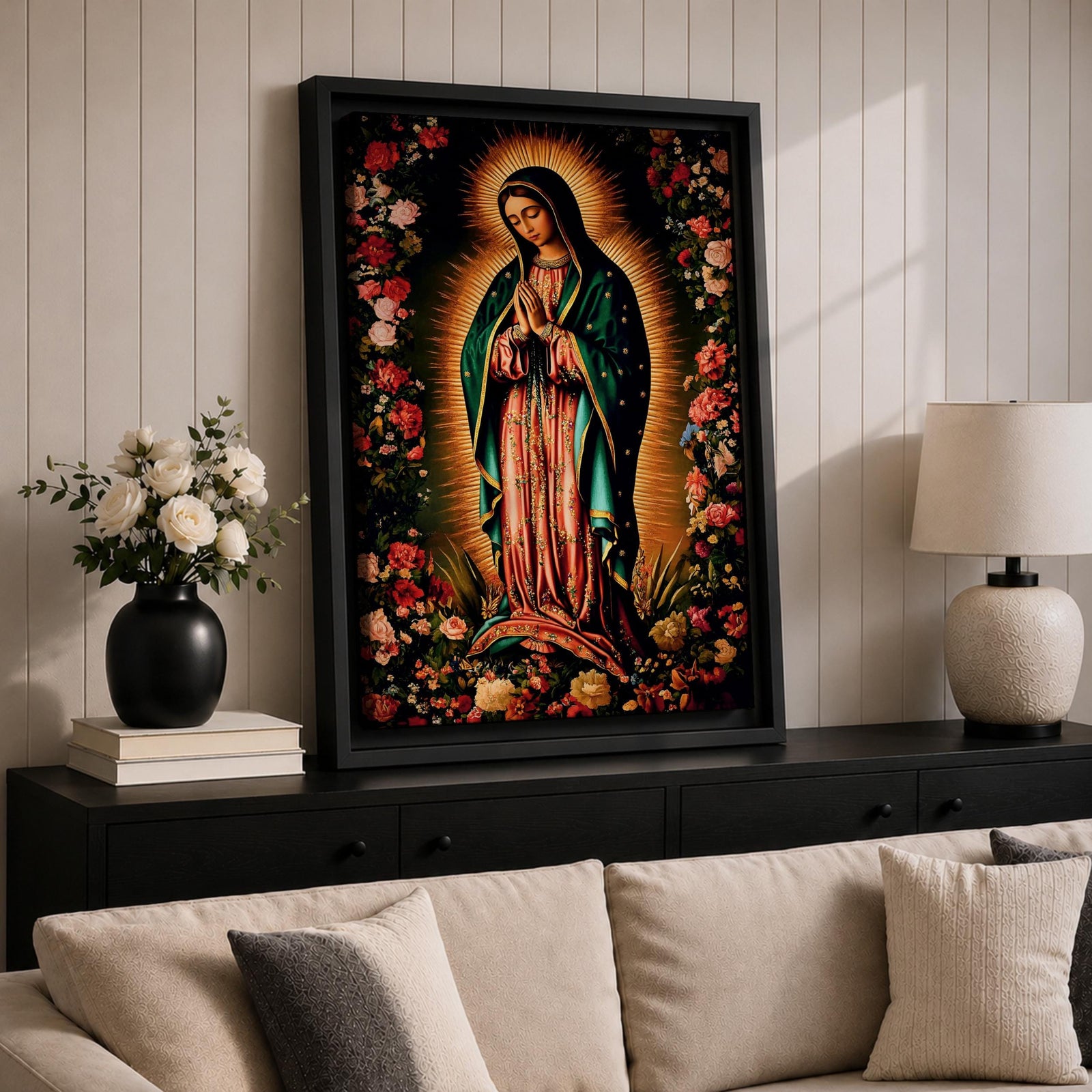 A detailed framed canvas print depicting Our Lady of Guadalupe, showing the Virgin of Guadalupe surrounded by a floral border with radiant light emanating behind her, rendered in a traditional Mexican religious art style with vivid colors and intricate floral patterns.