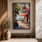A vibrant Mediterranean café scene featuring a cozy outdoor patio with tables and chairs, colorful flowers cascading from balconies, and a distant view of the sea. The artwork captures a lively coastal atmosphere with impressionistic brushstrokes and rich textures, evoking a warm and inviting cityscape.