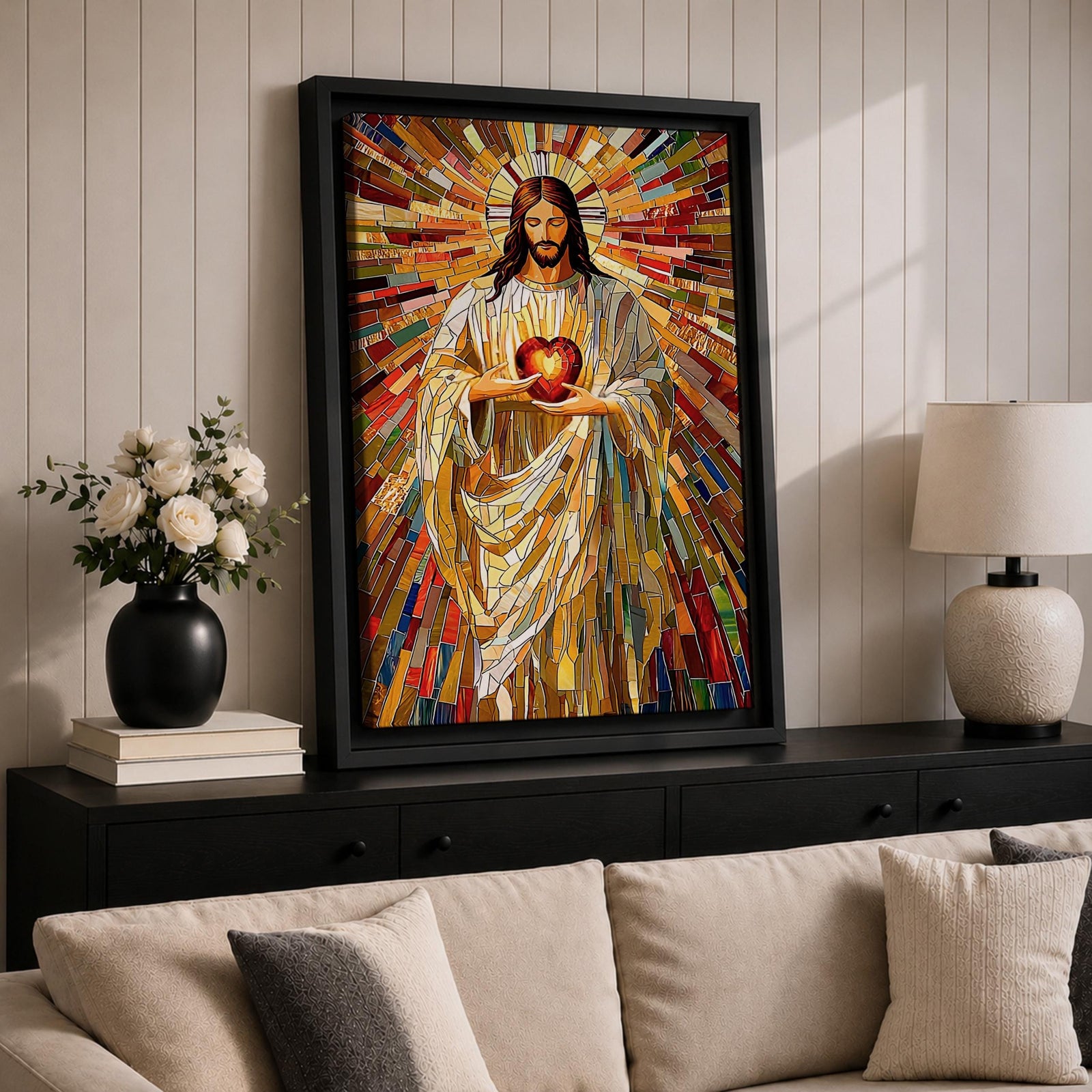 A vibrant mosaic stained glass style artwork depicting the Sacred Heart of Jesus holding a glowing heart. The image features intricate geometric glass fragments in warm tones radiating outward, emphasizing the central figure with flowing robes and a halo behind his head, rendered in a religious mosaic style.