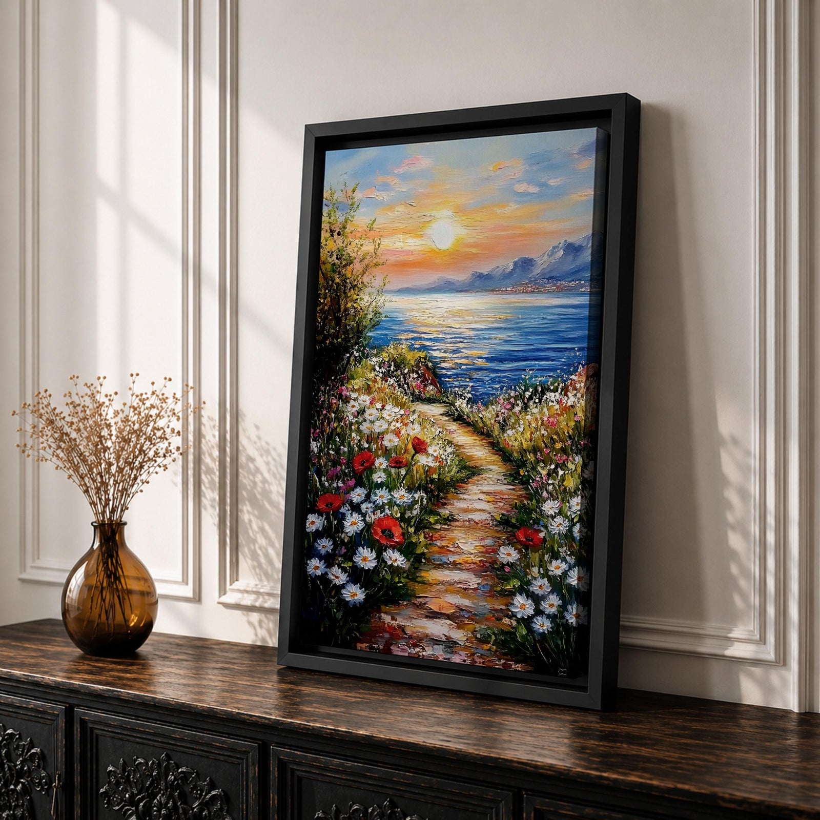 An impasto style framed canvas painting depicting a coastal sunset path bordered by vibrant wildflowers leading to a calm sea with distant mountains under a colorful sky. The textured brush strokes emphasize the natural landscape and seaside atmosphere.