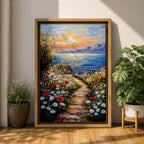 An impasto style framed canvas painting depicting a coastal sunset path bordered by vibrant wildflowers leading to a calm sea with distant mountains under a colorful sky. The textured brush strokes emphasize the natural landscape and seaside atmosphere.