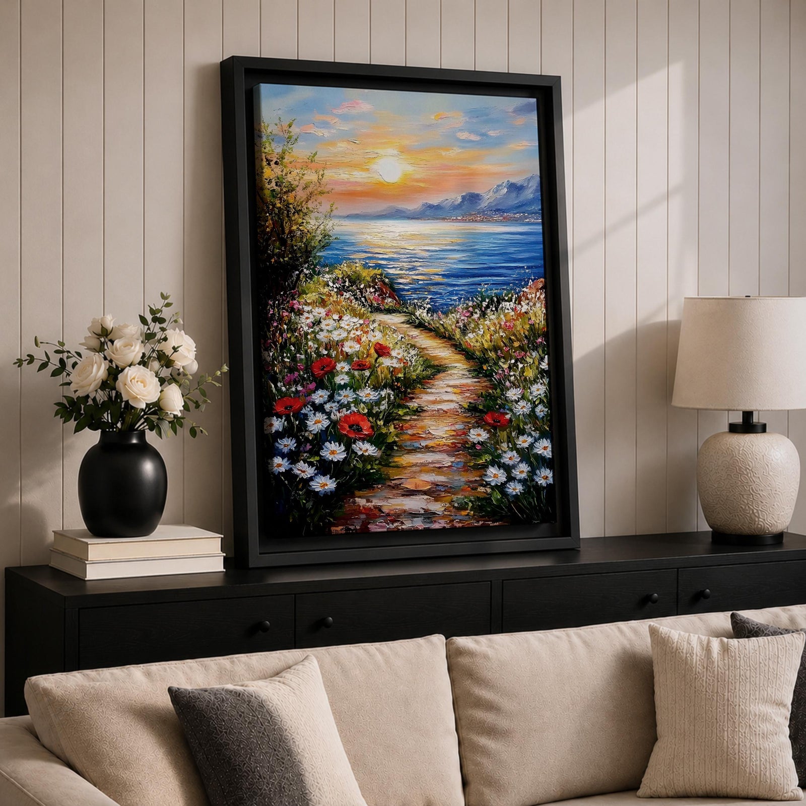 An impasto style framed canvas painting depicting a coastal sunset path bordered by vibrant wildflowers leading to a calm sea with distant mountains under a colorful sky. The textured brush strokes emphasize the natural landscape and seaside atmosphere.