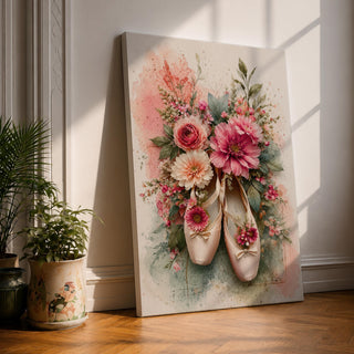 A watercolor style floral artwork featuring a pair of ballet pointe shoes adorned with vibrant pink, peach, and cream flowers and green leaves. The composition blends delicate botanical elements with the soft texture of the ballet shoes, creating a harmonious and elegant floral-themed piece.