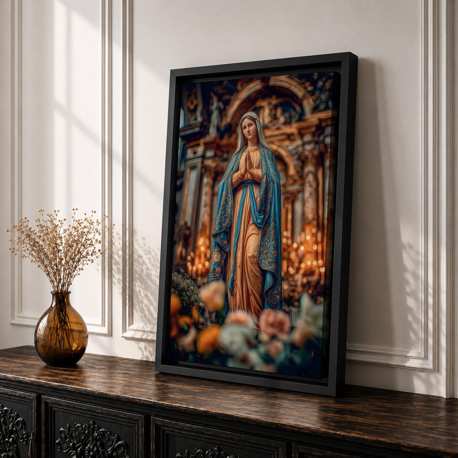 A detailed framed canvas print depicting Our Lady of Lourdes, showing the Virgin Mary in a traditional pose with hands clasped in prayer, wearing a flowing robe and veil, set against a softly blurred background of candles and floral elements, emphasizing religious devotion and reverence.