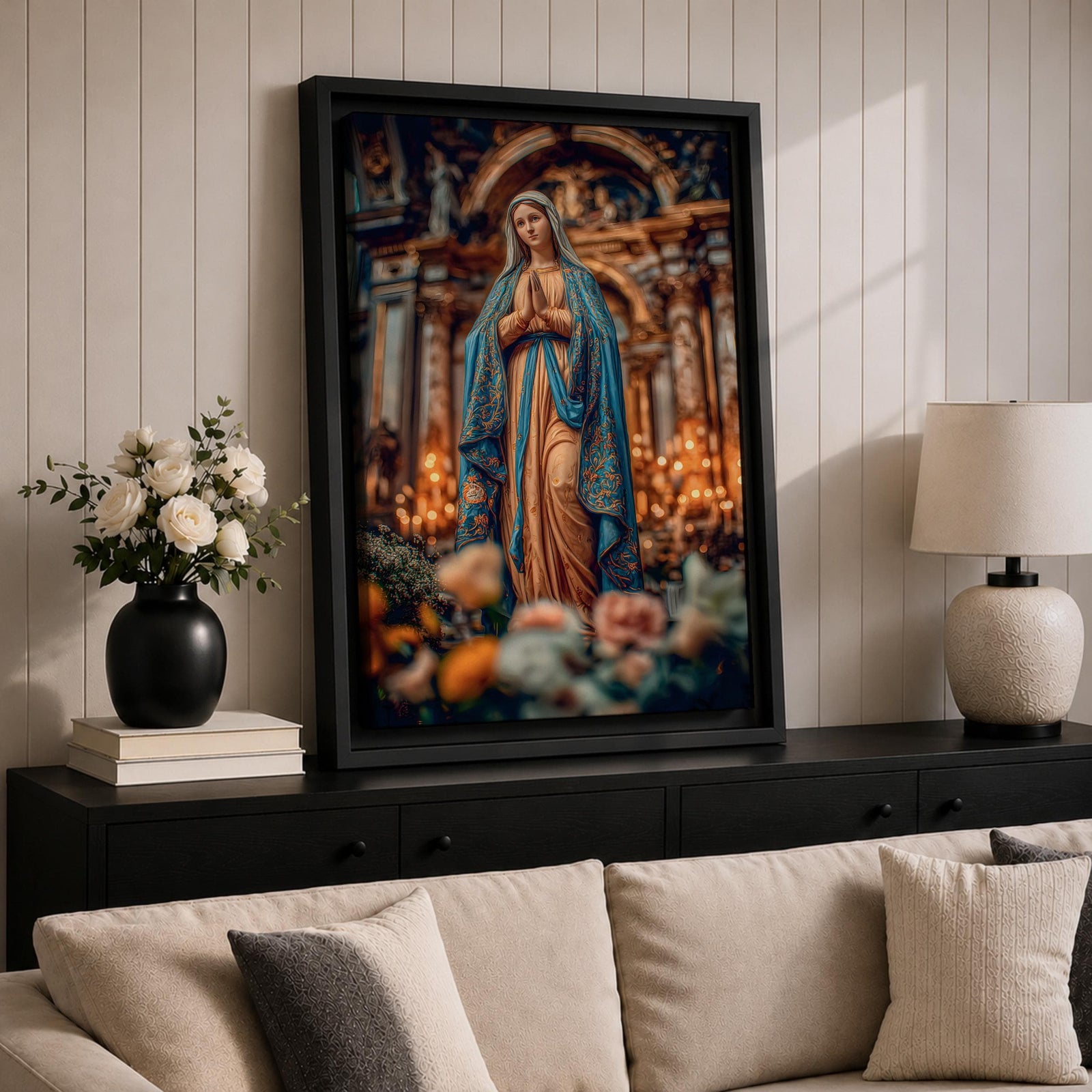A detailed framed canvas print depicting Our Lady of Lourdes, showing the Virgin Mary in a traditional pose with hands clasped in prayer, wearing a flowing robe and veil, set against a softly blurred background of candles and floral elements, emphasizing religious devotion and reverence.