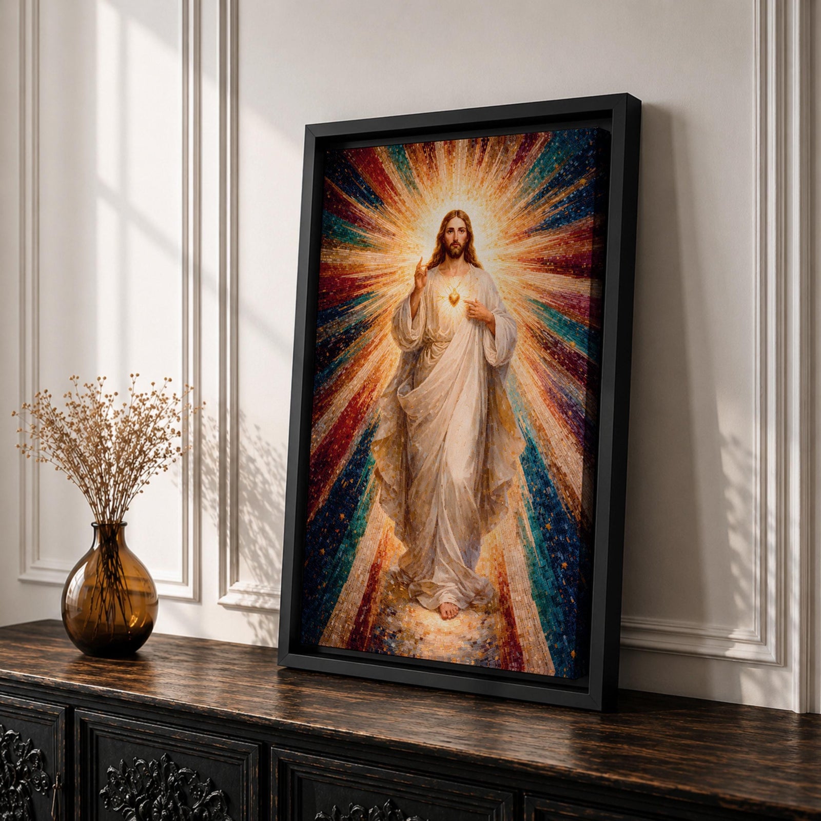 A mosaic-style framed canvas depicting the Sacred Heart of Jesus with radiant beams of light emanating from the heart. The figure is dressed in flowing robes with one hand raised in blessing and the other pointing to the glowing heart, set against a vibrant, colorful mosaic background.
