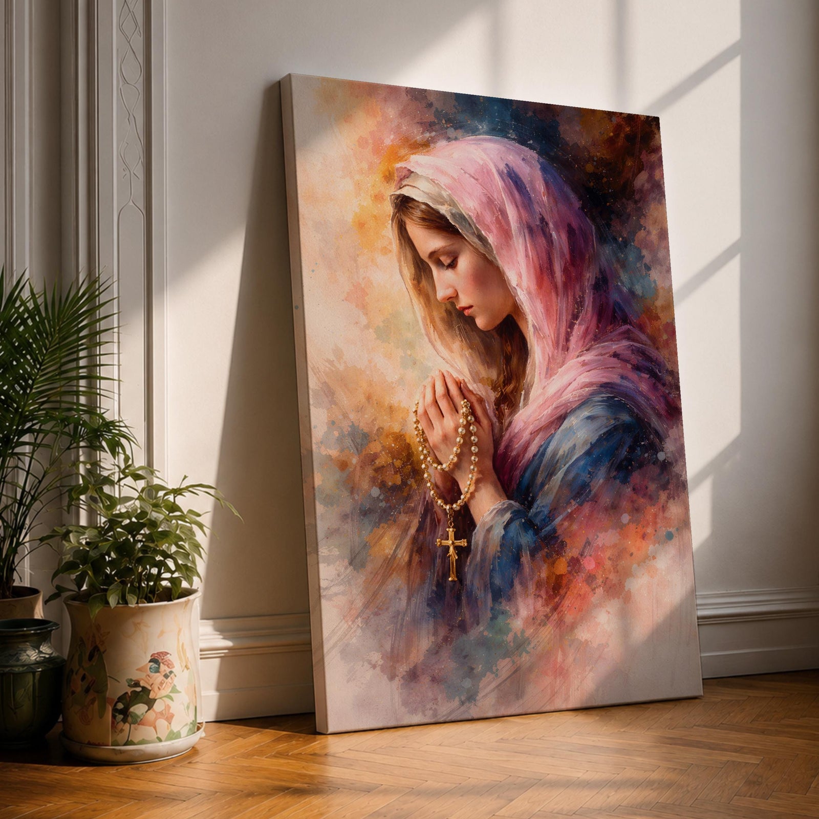 A watercolor style painting of the Virgin Mary wearing a pink hooded shawl, holding a rosary with a gold cross, her eyes closed in prayer, surrounded by soft, blended warm and cool colors creating a serene and contemplative atmosphere.