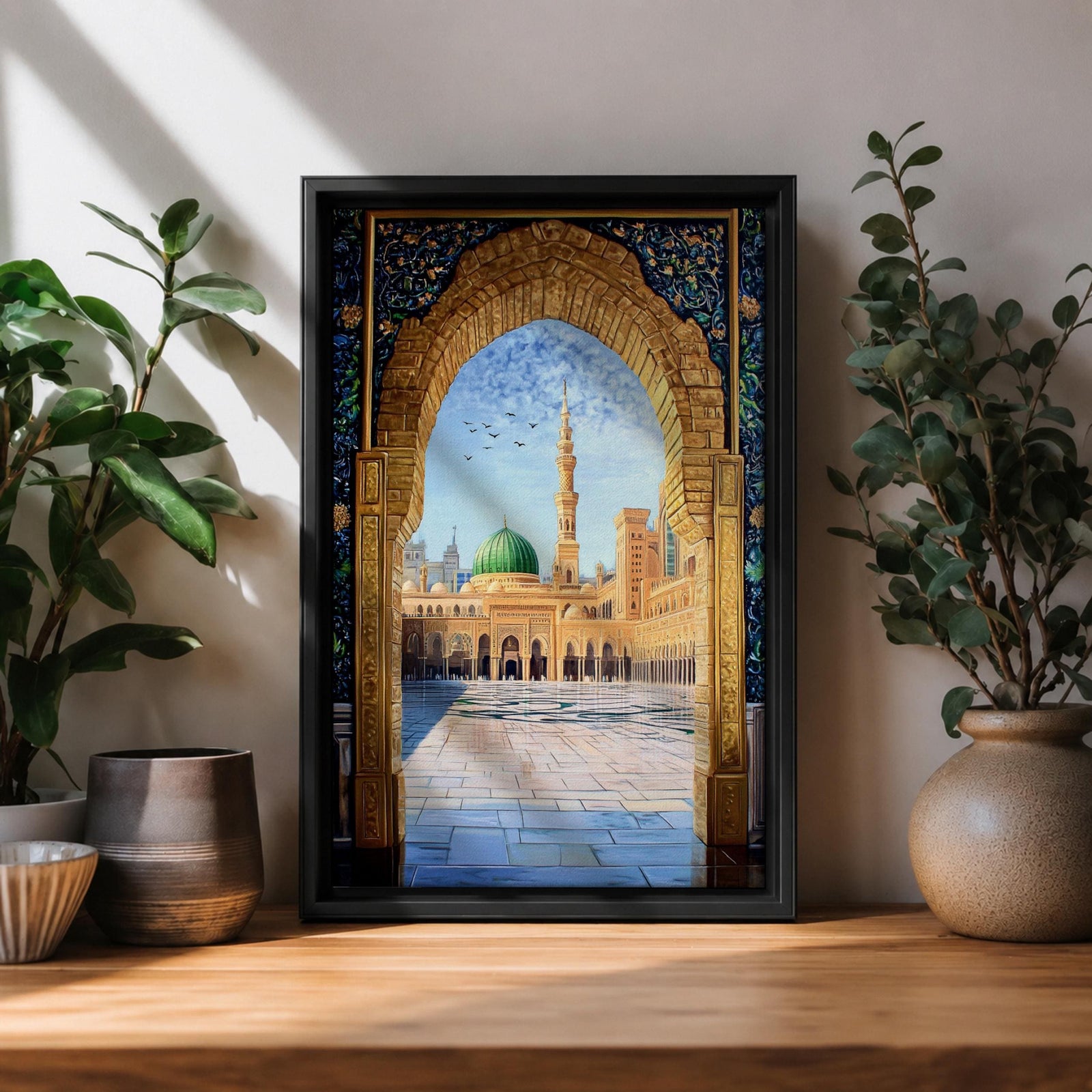 Artwork of Masjid Al Nabawi in Medina seen through an ornate stone arch with intricate Islamic patterns, featuring the iconic green dome, tall minaret, and the mosque’s peaceful courtyard beneath a bright blue sky with birds in flight.