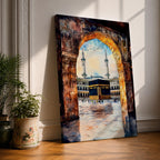 Watercolor-style painting of the Kaaba in Masjid al-Haram viewed through a large stone archway, showing the sacred courtyard with pilgrims and two tall minarets rising above the mosque.