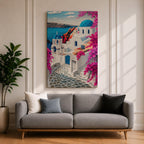 A vibrant framed canvas depicting Santorini, Greece, featuring iconic white buildings with blue domes, winding cobblestone paths, and bright bougainvillea flowers overlooking a deep blue sea, rendered in a clean, graphic style emphasizing architectural shapes and Mediterranean coastal charm.