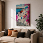 A vibrant framed canvas depicting Santorini, Greece, featuring iconic white buildings with blue domes, winding cobblestone paths, and bright bougainvillea flowers overlooking a deep blue sea, rendered in a clean, graphic style emphasizing architectural shapes and Mediterranean coastal charm.