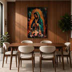 A vibrant framed canvas painting of Our Lady of Guadalupe depicts the Virgin of Guadalupe with hands clasped in prayer, wearing a teal mantle adorned with gold stars and surrounded by radiant light. The foreground features a colorful array of flowers, emphasizing the Catholic religious theme.