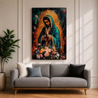 A vibrant framed canvas painting of Our Lady of Guadalupe depicts the Virgin of Guadalupe with hands clasped in prayer, wearing a teal mantle adorned with gold stars and surrounded by radiant light. The foreground features a colorful array of flowers, emphasizing the Catholic religious theme.