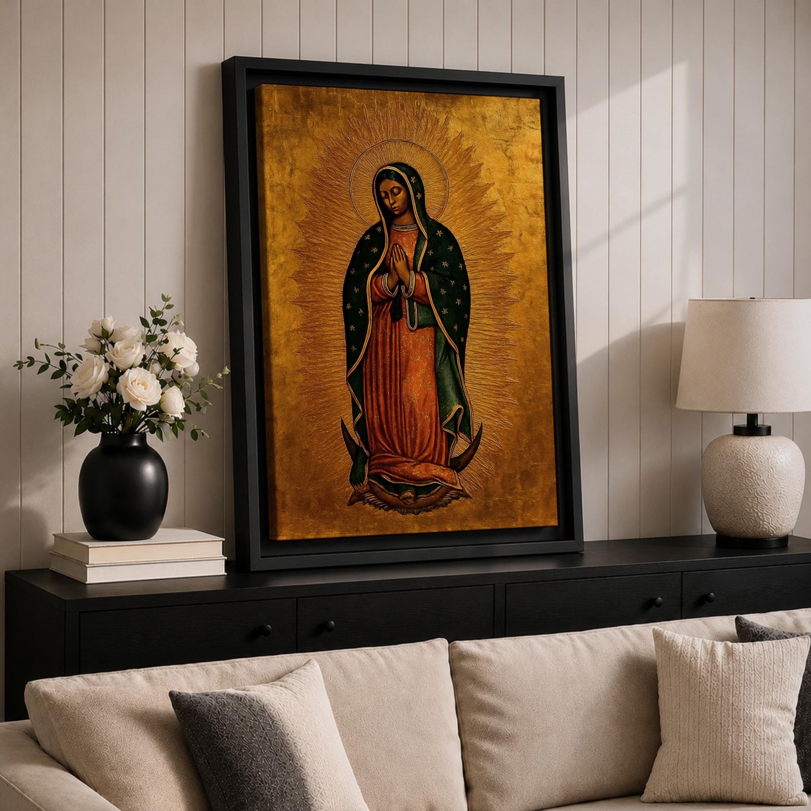 A traditional devotional depiction of Our Lady of Guadalupe standing with hands folded in prayer, wearing a rose colored gown and a teal mantle covered in gold stars, surrounded by radiant golden sun rays and standing above a crescent moon supported by an angel, rendered in classic Mexican Catholic icon style with rich colors and sacred symbolism.