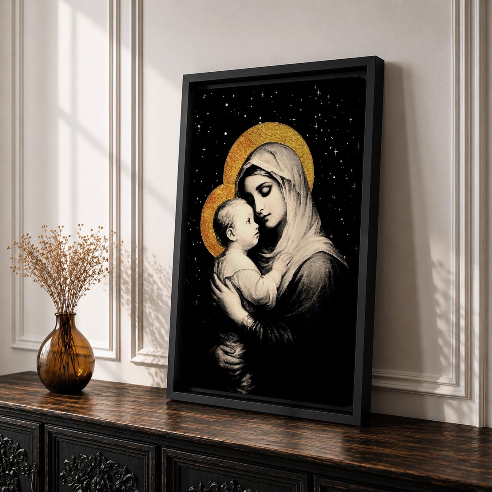 A framed canvas artwork depicting Madonna and Child with golden halos against a starry black background. The image shows the Virgin Mary tenderly holding the infant Jesus, rendered in a classical style with detailed shading and a serene expression, emphasizing their close bond.