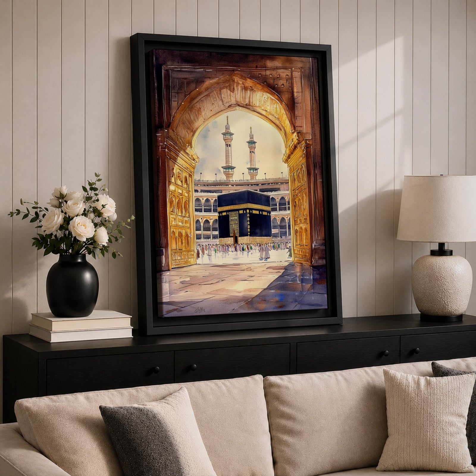 Watercolor-style artwork of the Kaaba at Masjid Al Haram in Mecca viewed through a grand mosque archway with open golden doors and pilgrims gathered in the courtyard beneath tall minarets.