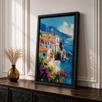 This impasto style framed canvas depicts the Amalfi Coast featuring a cluster of Italian villas with terracotta roofs perched on cliffs overlooking a vibrant blue Mediterranean sea under a partly cloudy sky, with colorful flowers in the foreground enhancing the coastal landscape scene.