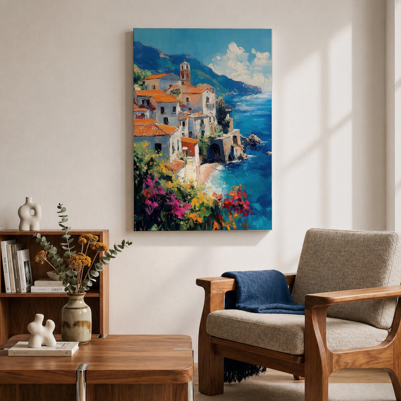 This impasto style framed canvas depicts the Amalfi Coast featuring a cluster of Italian villas with terracotta roofs perched on cliffs overlooking a vibrant blue Mediterranean sea under a partly cloudy sky, with colorful flowers in the foreground enhancing the coastal landscape scene.