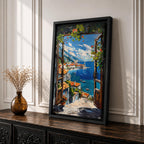 A vibrant framed canvas painting depicting a Mediterranean window opening to a coastal seaside view with terracotta rooftops, boats on deep blue ocean waters, and distant mountains under a bright sky. The artwork captures a scenic landscape with detailed brushstrokes and rich textures.
