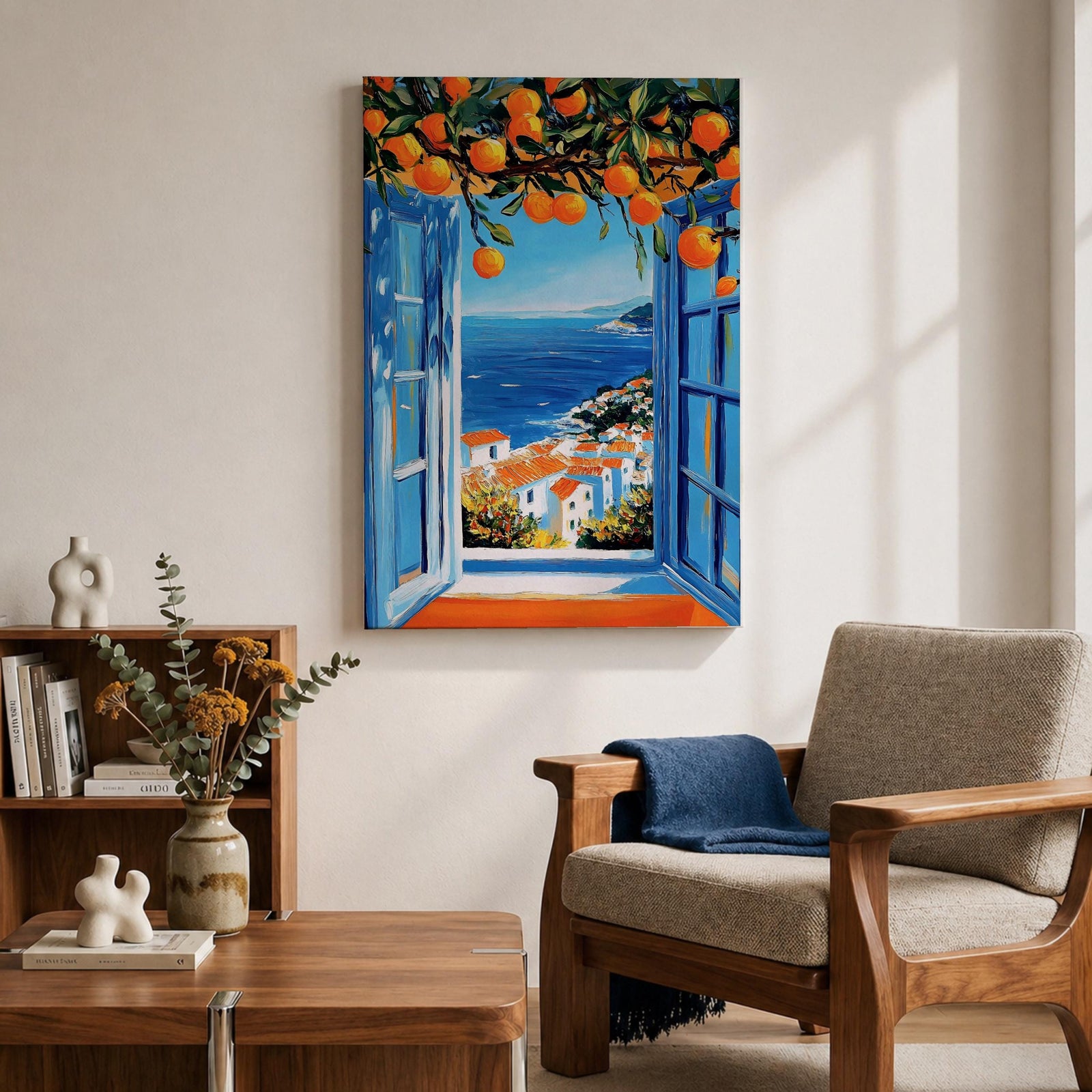 A vibrant framed canvas painting depicting an open Mediterranean-style window with blue shutters overlooking a coastal landscape. Above the window, ripe orange fruits hang from branches, framing a scenic view of white houses with terracotta roofs and a deep blue sea under a clear sky, rendered in a vivid, realistic style.