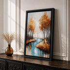 A framed canvas painting depicting an autumn river winding through a forest with tall trees in fall colors. The artwork features a vintage style with textured brushstrokes, emphasizing the natural landscape and serene water reflections in warm rustic tones.