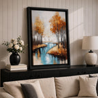 A framed canvas painting depicting an autumn river winding through a forest with tall trees in fall colors. The artwork features a vintage style with textured brushstrokes, emphasizing the natural landscape and serene water reflections in warm rustic tones.