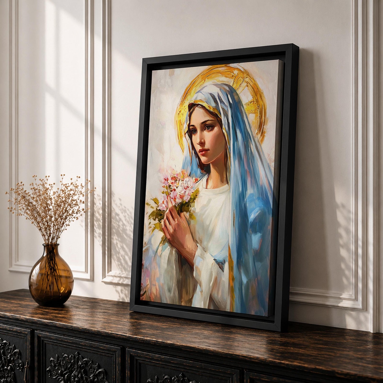 A vintage-style framed canvas painting of Blessed Virgin Mary depicted as Our Lady of Grace, holding a bouquet of flowers with a golden halo behind her head. The artwork features soft brushstrokes and a classic religious portrait style emphasizing serene expression and traditional Marian iconography.