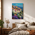 This impasto style painting depicts a vibrant Mediterranean village with terracotta-roofed houses clustered on a hillside surrounded by lush greenery and colorful flowers, set against a bright blue sky and distant mountains, capturing the charm and warmth of a coastal landscape.