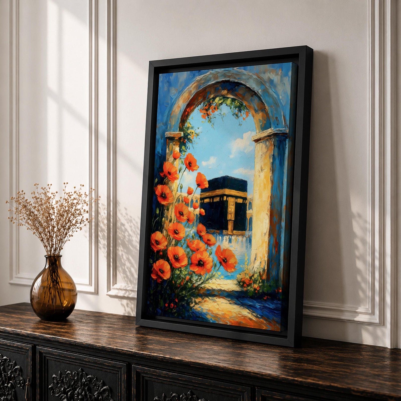 A vibrant painting depicting the Kaaba framed by an ancient stone arch adorned with bright orange flowers. The artwork captures the iconic Islamic holy site with a clear blue sky background, rendered in a realistic style emphasizing architectural and floral details.