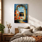 A vibrant painting depicting the Kaaba framed by an ancient stone arch adorned with bright orange flowers. The artwork captures the iconic Islamic holy site with a clear blue sky background, rendered in a realistic style emphasizing architectural and floral details.