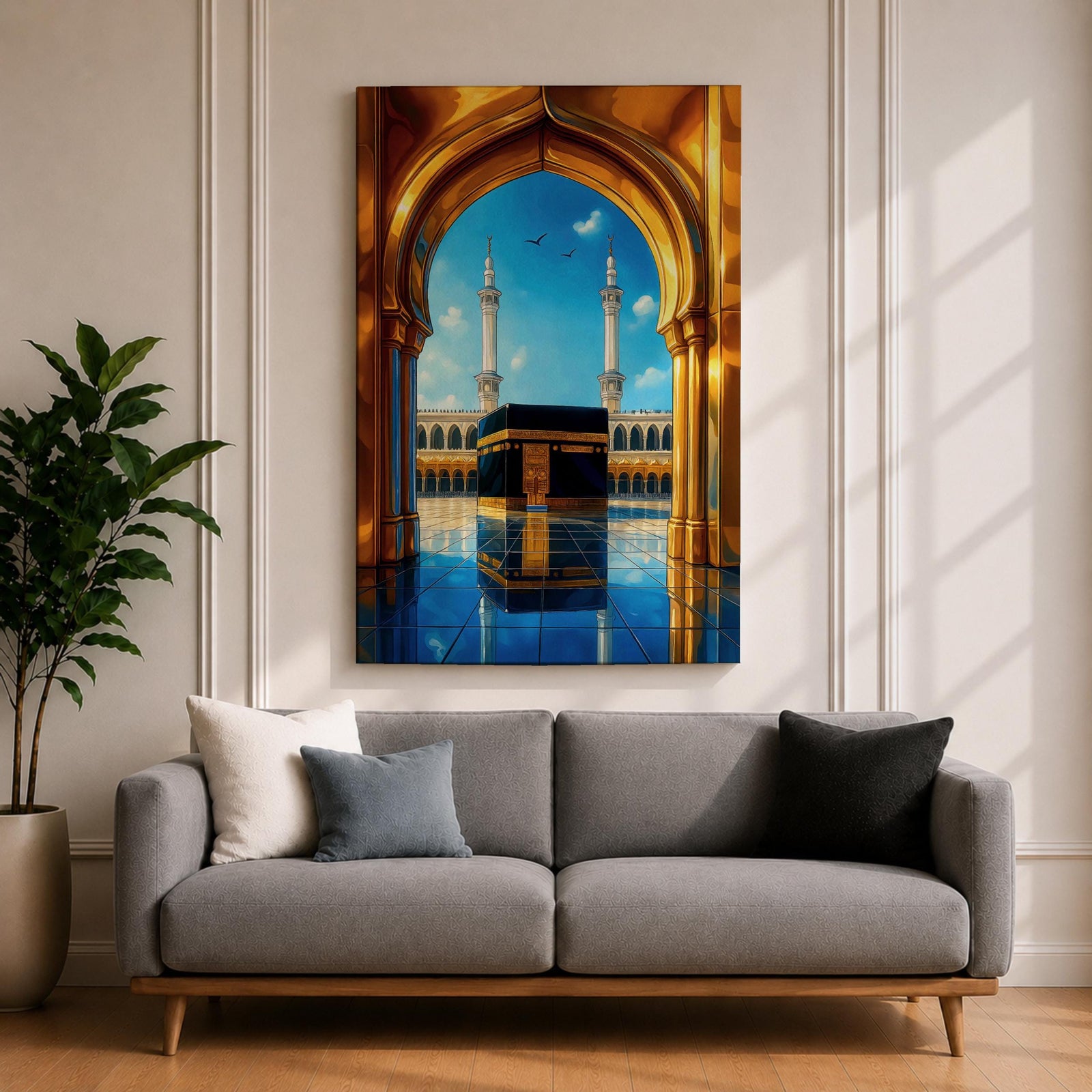 A vibrant framed canvas artwork depicting the Kaaba viewed through a golden arched doorway at Masjid Al Haram in Mecca. The scene shows the iconic black cube structure with gold detailing, two minarets in the background, and a reflective tiled floor under a bright blue sky with birds flying.
