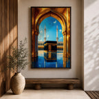 A vibrant framed canvas artwork depicting the Kaaba viewed through a golden arched doorway at Masjid Al Haram in Mecca. The scene shows the iconic black cube structure with gold detailing, two minarets in the background, and a reflective tiled floor under a bright blue sky with birds flying.