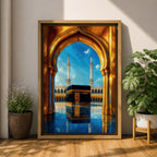 A vibrant framed canvas artwork depicting the Kaaba viewed through a golden arched doorway at Masjid Al Haram in Mecca. The scene shows the iconic black cube structure with gold detailing, two minarets in the background, and a reflective tiled floor under a bright blue sky with birds flying.
