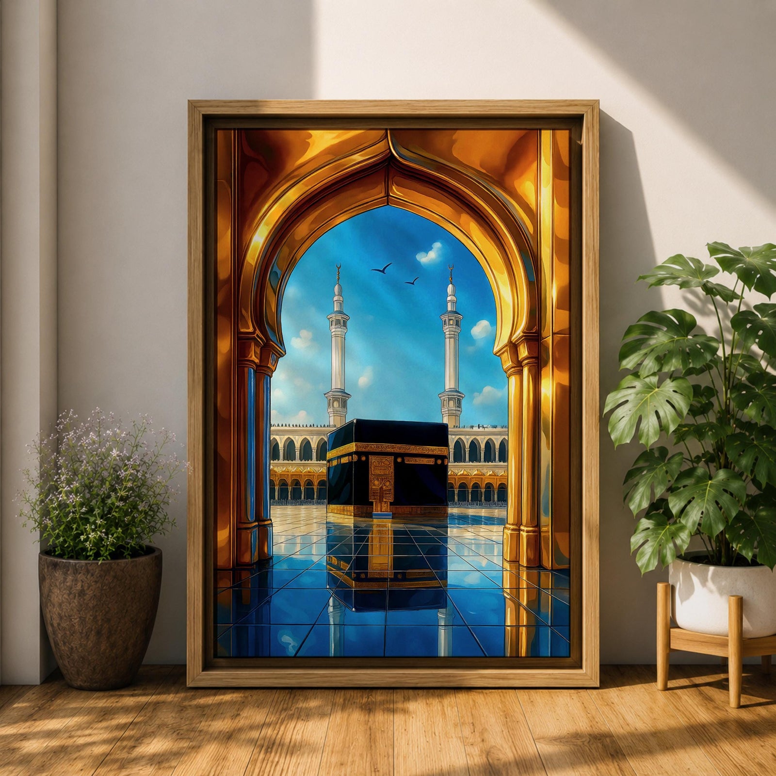 A vibrant framed canvas artwork depicting the Kaaba viewed through a golden arched doorway at Masjid Al Haram in Mecca. The scene shows the iconic black cube structure with gold detailing, two minarets in the background, and a reflective tiled floor under a bright blue sky with birds flying.
