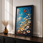 This impasto style framed canvas features a vibrant monarch butterfly fluttering above a cluster of white daisies with yellow centers against a textured blue sky background. The thick brushstrokes create a rich, textured floral composition emphasizing natural beauty and butterfly life in a lively garden scene.