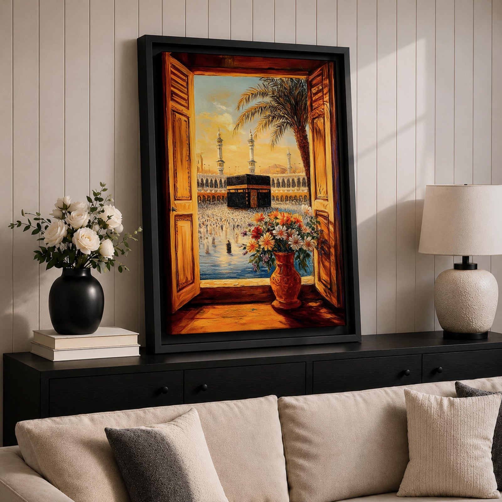 Painting of the Kaaba inside Masjid al Haram seen through open wooden window shutters forming a window view toward the sacred courtyard, with tall mosque minarets rising behind the Kaaba, a palm tree arching across the sky, and a vase of flowers in the foreground overlooking pilgrims gathered around the sanctuary.